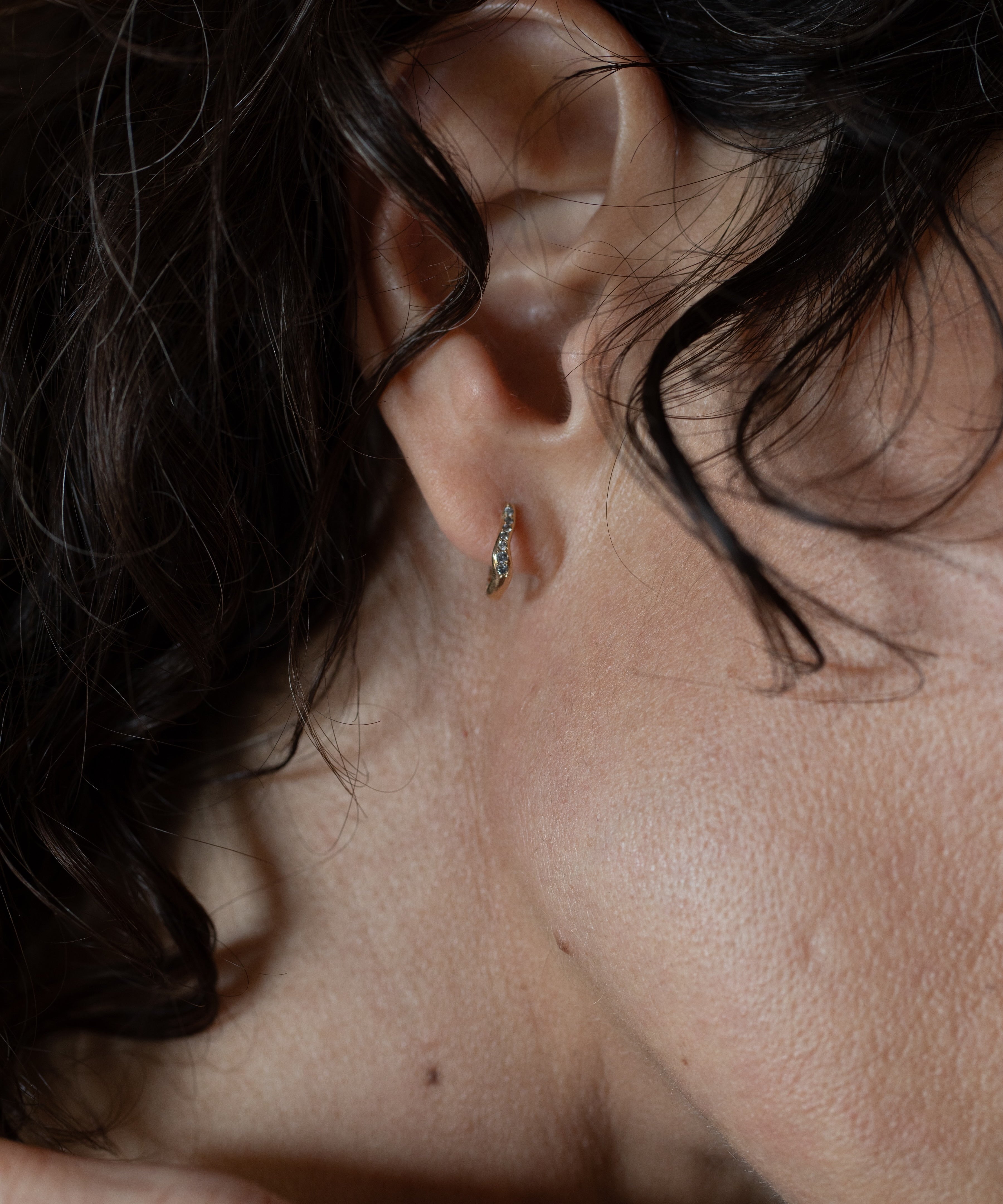 TILDA MINI Diamond Huggie Hoop Earrings texture close-up showing lost wax cast detail, 14K Fairmined gold