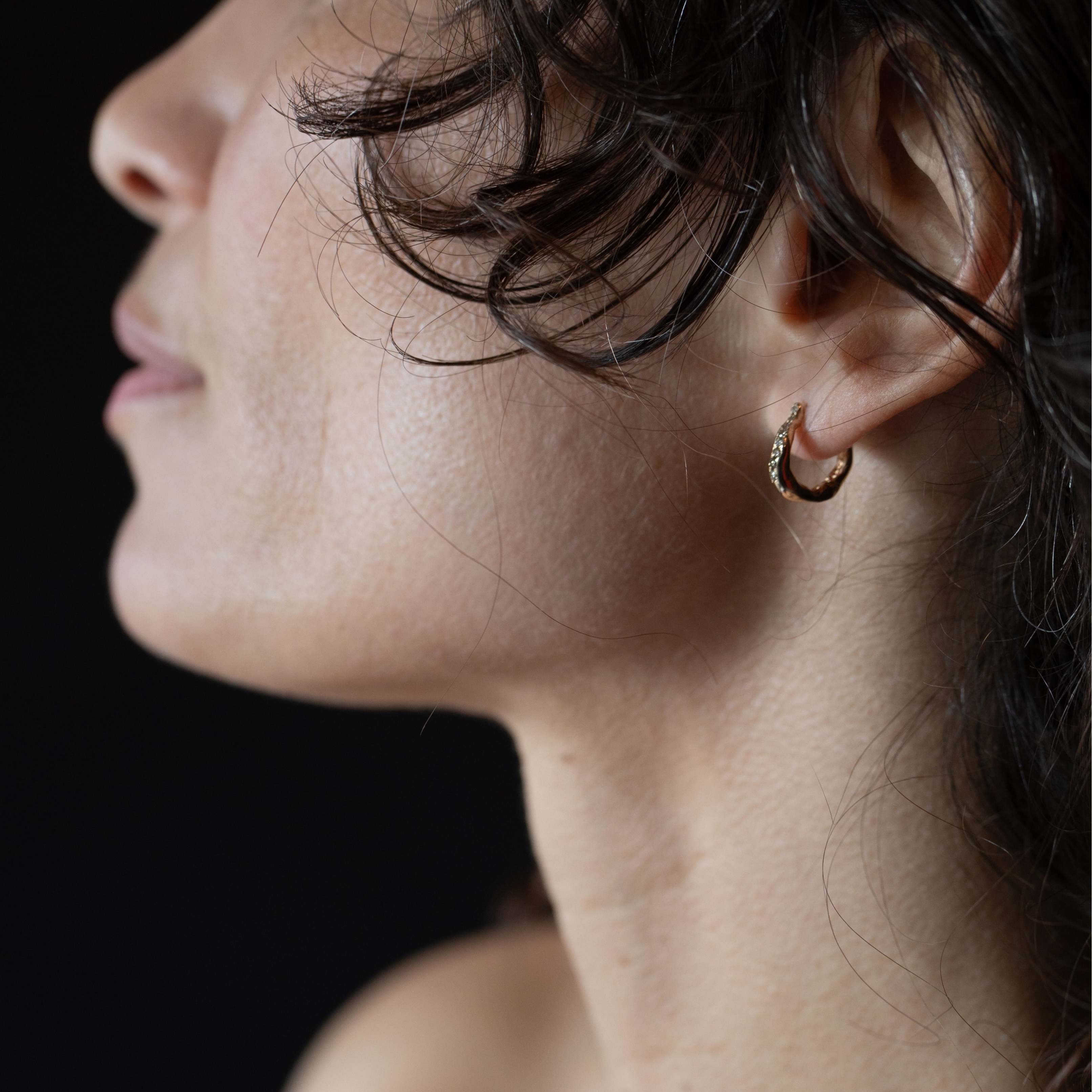 TILDA Diamond Huggie Hoop Earrings worn on ear, 14K Fairmined gold