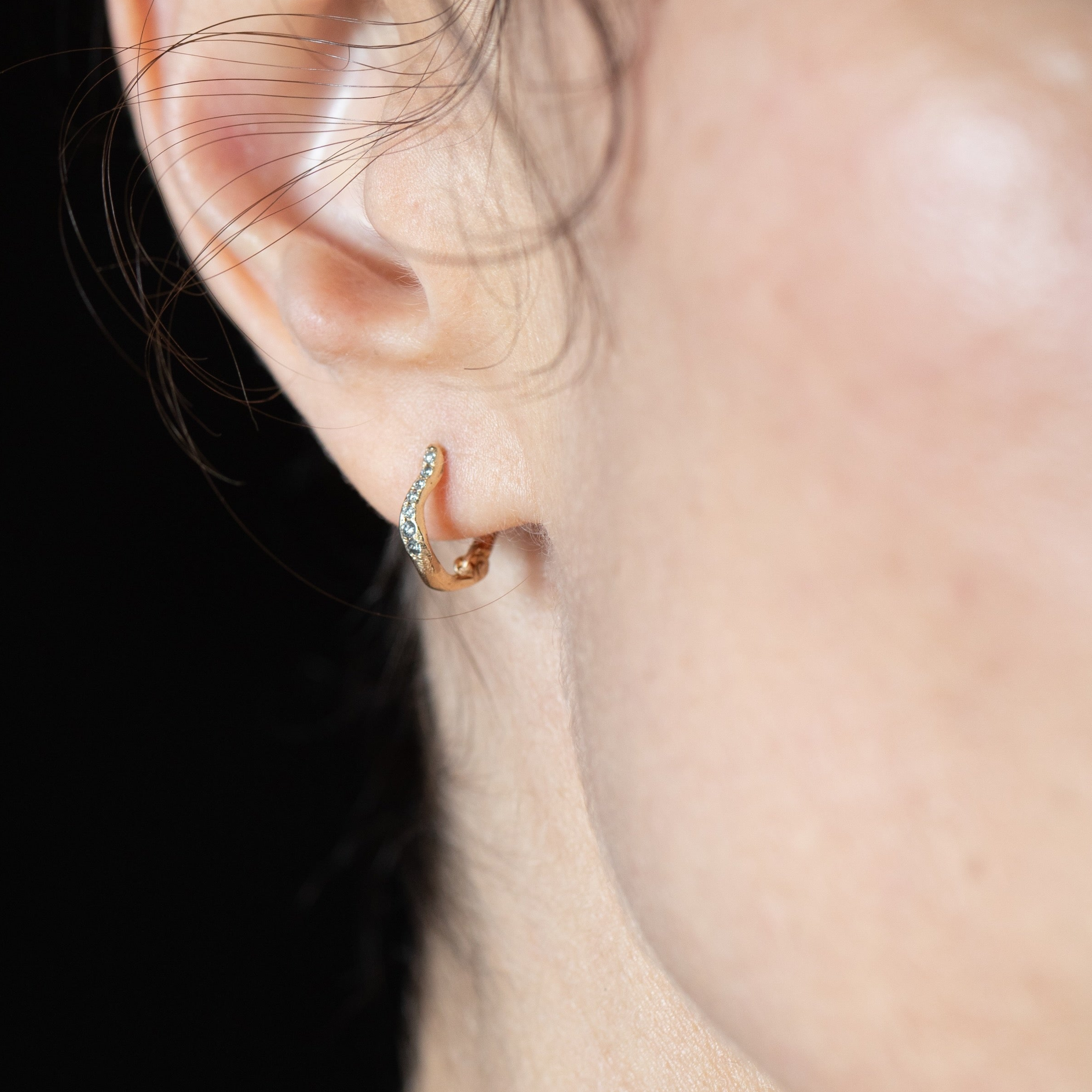 TILDA MINI Diamond Huggie Hoop Earrings worn on ear, 14K Fairmined gold
